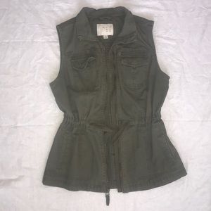 Army green vest with waist cinch.